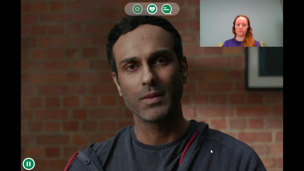 A screenshot from the Hear to Listen experience. It shows a simulated web call with Isaac. In the top right corner the learner can see their own webcam feed.