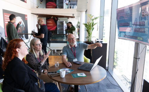 A group of people trying out a learning solution created for NATS.