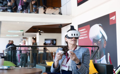 A woman using a Meta Quest 3 virtual reality headset.